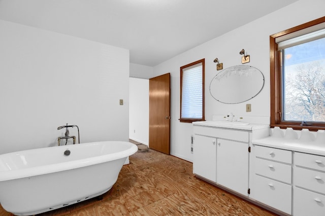 bathroom featuring hardwood / wood-style floors, a bathing tub, and oversized vanity