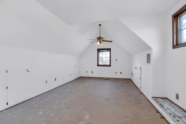 bonus room with ceiling fan, lofted ceiling, and a healthy amount of sunlight