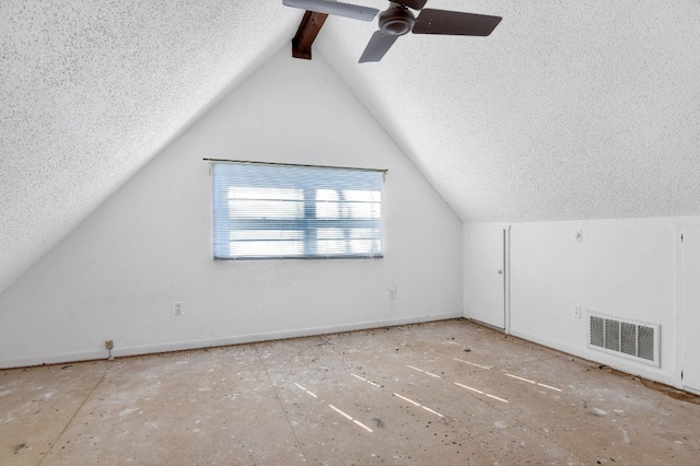 additional living space featuring lofted ceiling, a textured ceiling, and ceiling fan