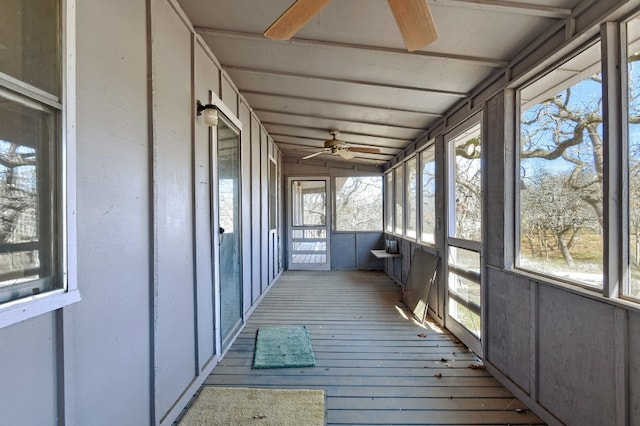 unfurnished sunroom with ceiling fan