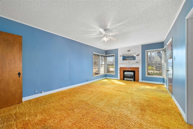 unfurnished living room featuring carpet, ceiling fan, and a textured ceiling