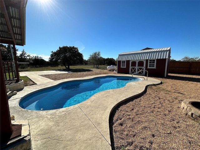 view of swimming pool featuring a patio and an outdoor structure