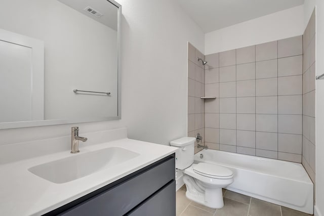 full bathroom featuring tiled shower / bath combo, toilet, tile patterned floors, and vanity