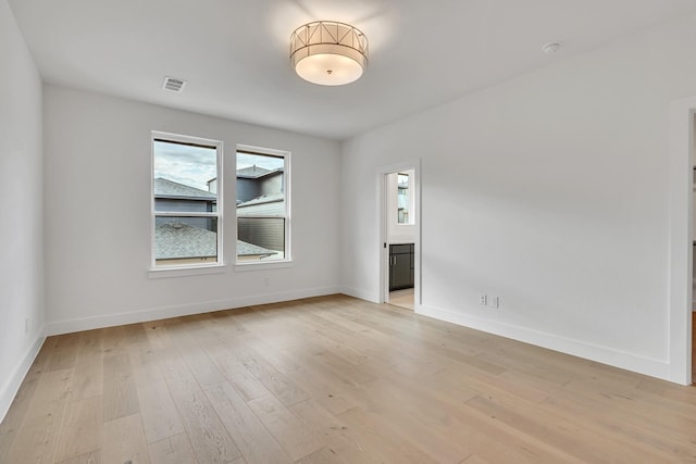 empty room with light hardwood / wood-style flooring