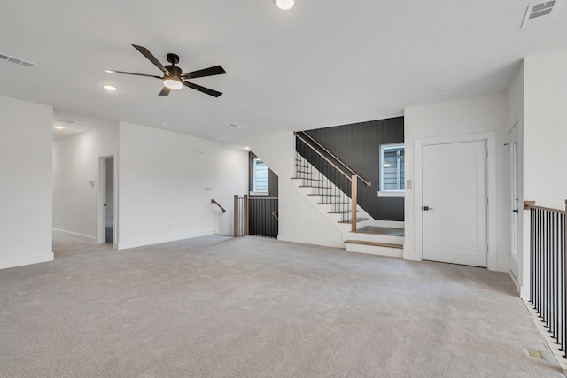 unfurnished living room with light carpet and ceiling fan