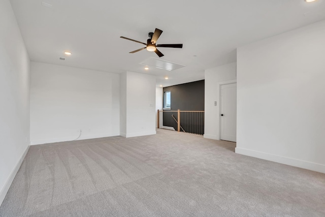 carpeted spare room featuring ceiling fan