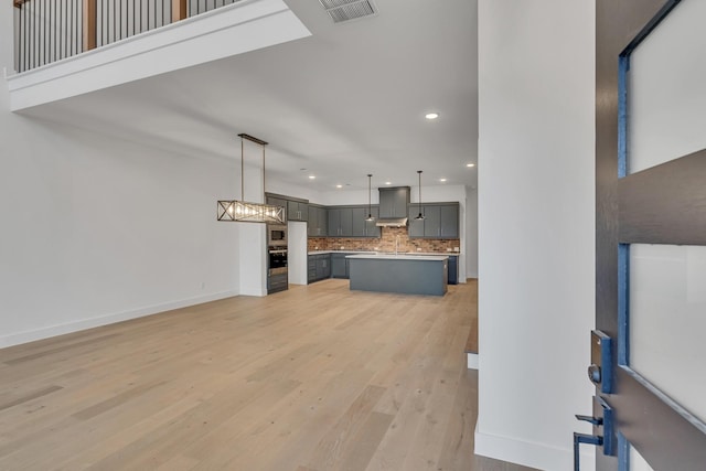 unfurnished living room featuring light wood-type flooring