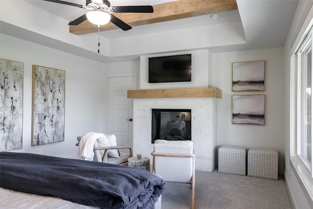 bedroom featuring light colored carpet, a raised ceiling, and ceiling fan