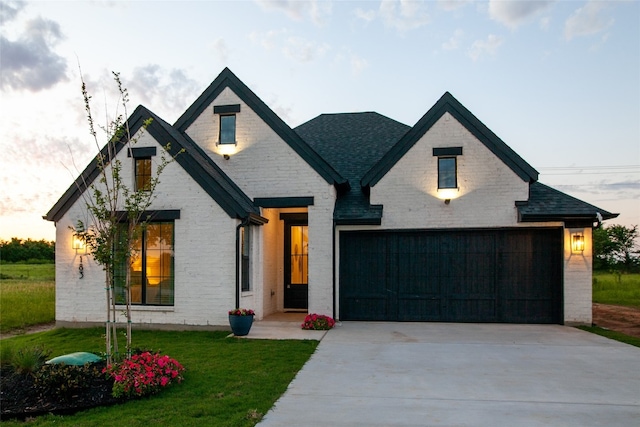 view of front facade with a garage and a yard