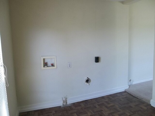 washroom with dark parquet floors and gas dryer hookup