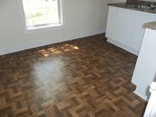 interior space featuring dark parquet floors and sink