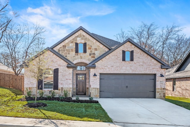 view of front of property featuring a garage and a front lawn