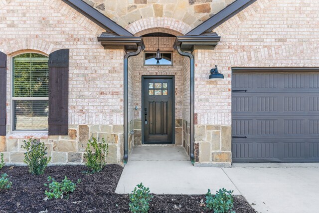 view of exterior entry featuring a garage