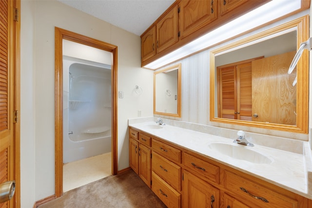 bathroom with vanity, a shower, and a textured ceiling