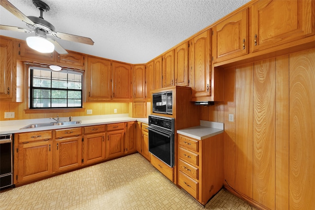 kitchen with ceiling fan, a textured ceiling, sink, and black appliances