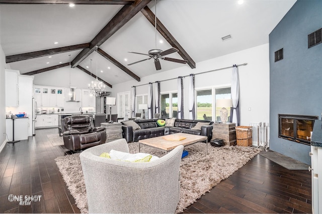 living area with visible vents, high vaulted ceiling, beam ceiling, dark wood-type flooring, and ceiling fan with notable chandelier