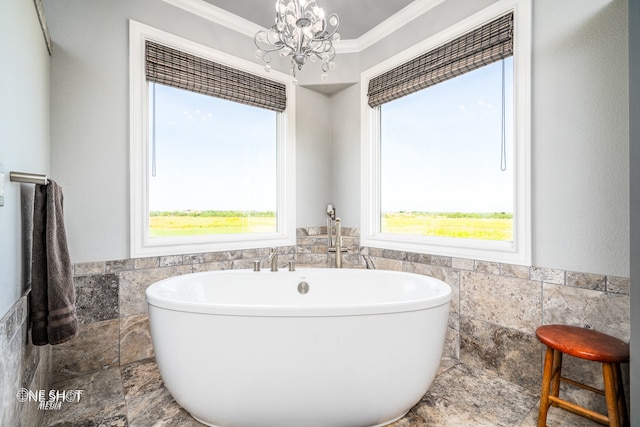 bathroom with a chandelier, a bath, tile walls, and ornamental molding