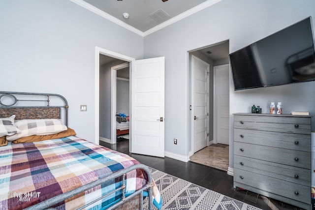 bedroom featuring crown molding and dark hardwood / wood-style flooring