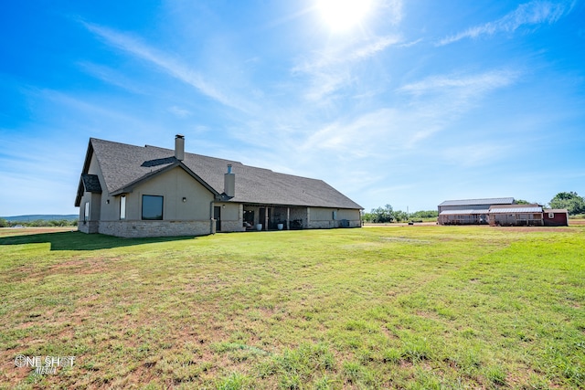 back of property featuring a yard