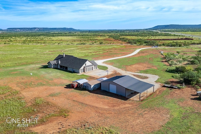 drone / aerial view featuring a rural view and a mountain view