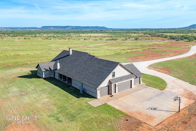 birds eye view of property with a mountain view