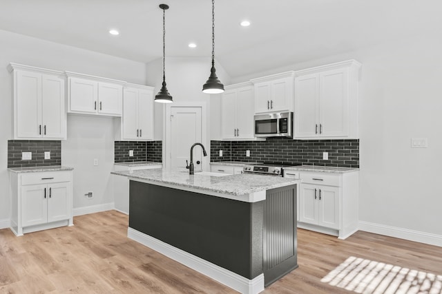 kitchen featuring sink, white cabinets, light hardwood / wood-style floors, and appliances with stainless steel finishes