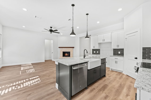 kitchen with white cabinets, ceiling fan, dishwasher, and sink