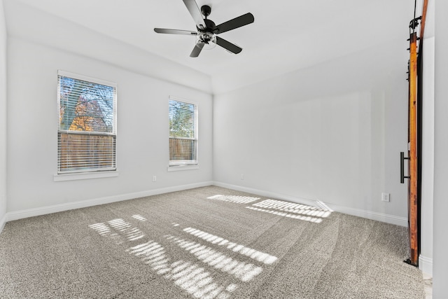 unfurnished room featuring ceiling fan and carpet floors