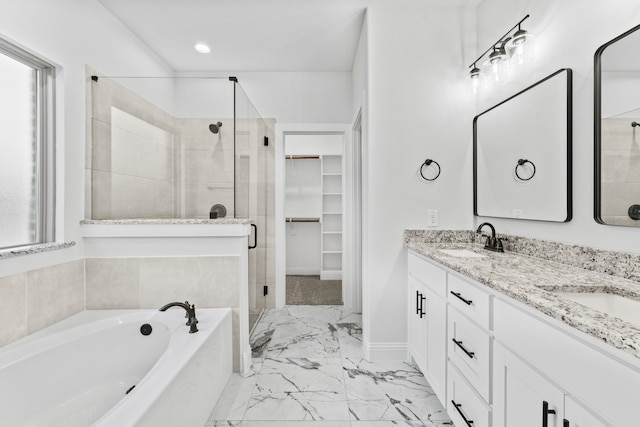 bathroom with vanity and shower with separate bathtub