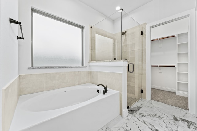 bathroom featuring separate shower and tub