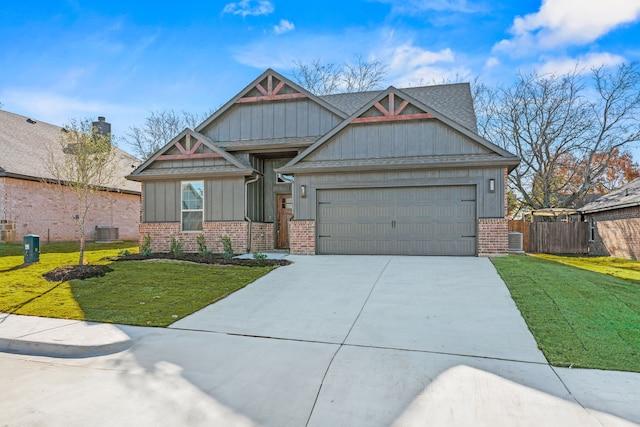 craftsman-style home with a front yard, central AC, and a garage