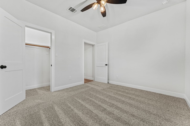 unfurnished bedroom featuring ceiling fan, a closet, and carpet