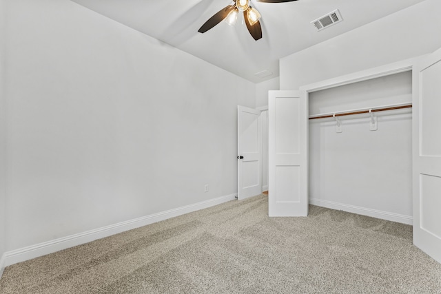 unfurnished bedroom with ceiling fan, a closet, and carpet floors