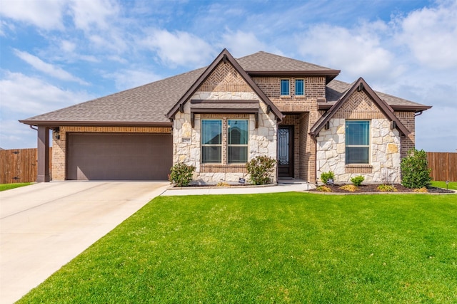 view of front of property with a garage, a shingled roof, fence, concrete driveway, and a front yard