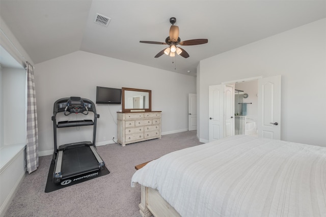 carpeted bedroom with a ceiling fan, visible vents, vaulted ceiling, baseboards, and ensuite bath