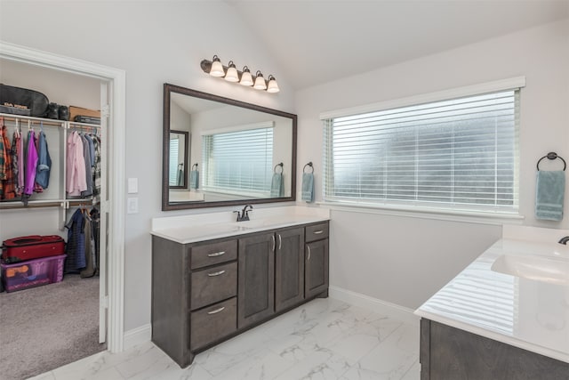 bathroom featuring vanity and vaulted ceiling