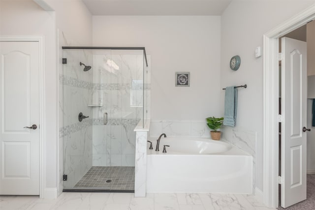 bathroom with marble finish floor, a garden tub, and a marble finish shower