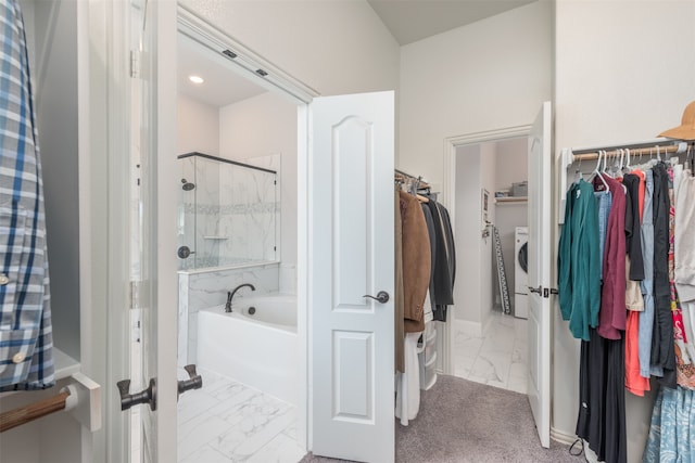 bathroom with washer / clothes dryer and separate shower and tub