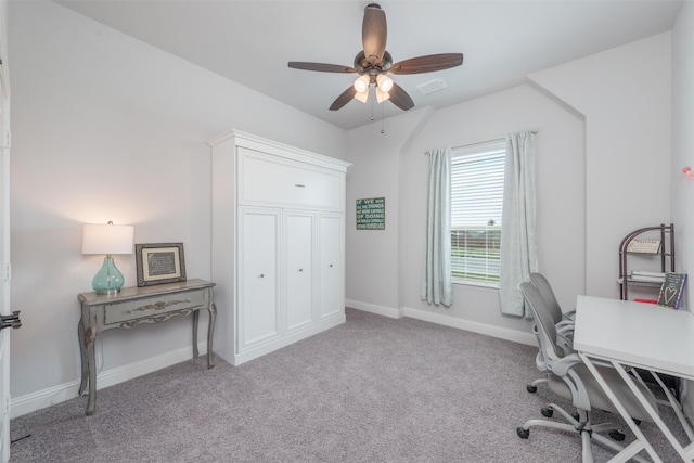 carpeted office with visible vents, baseboards, and ceiling fan