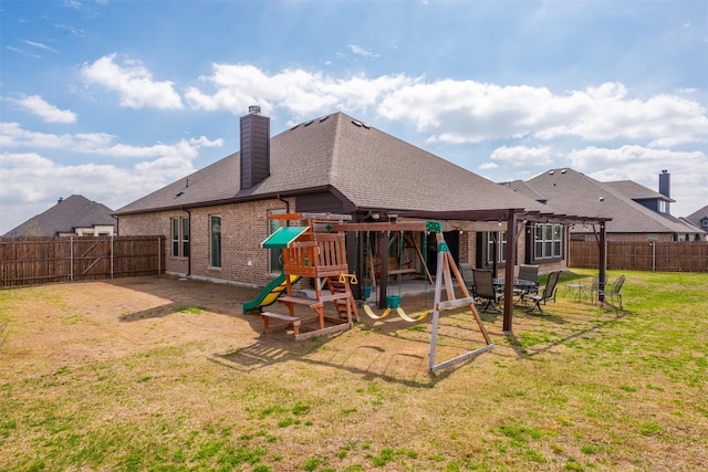 rear view of property with brick siding, a yard, a playground, a pergola, and a fenced backyard