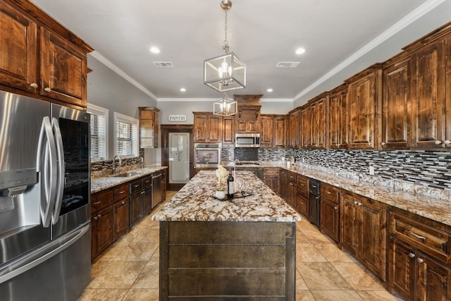 kitchen featuring stainless steel appliances, light stone counters, tasteful backsplash, and a kitchen island