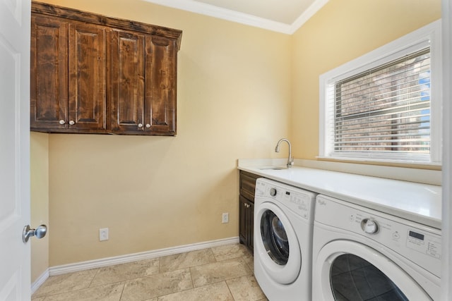 washroom with sink, light tile floors, ornamental molding, washer and clothes dryer, and cabinets