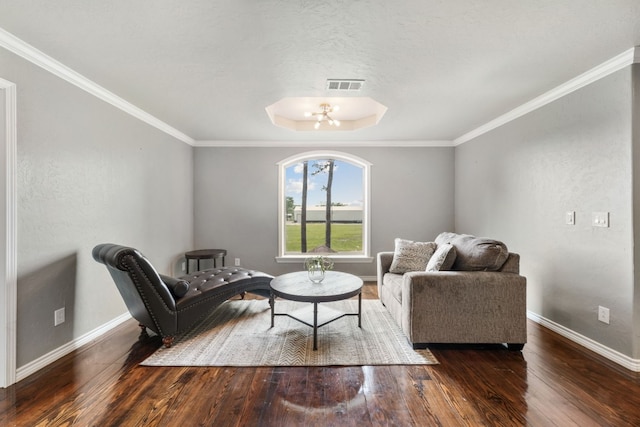 living area with crown molding and dark hardwood / wood-style flooring