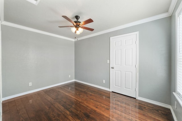 unfurnished room with ceiling fan, crown molding, and dark wood-type flooring