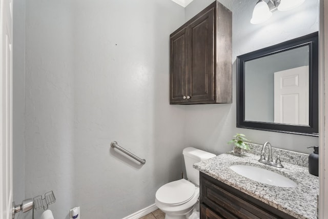 bathroom with toilet and vanity