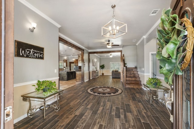 entryway featuring ornamental molding, dark hardwood / wood-style floors, and ceiling fan with notable chandelier