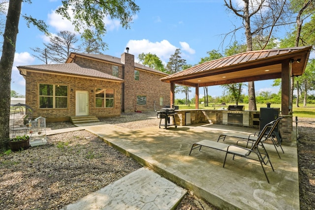 exterior space with exterior kitchen and a patio