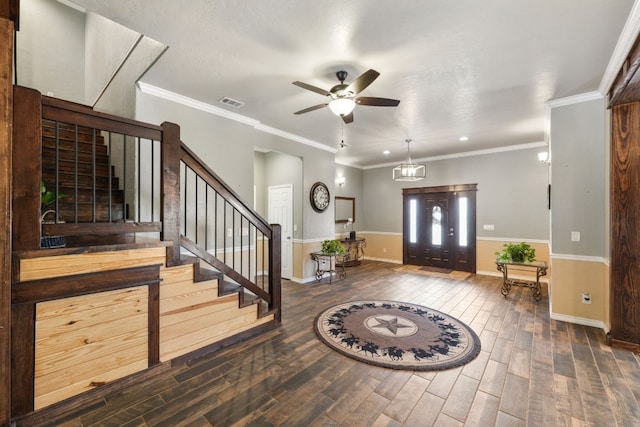 foyer entrance with dark hardwood / wood-style floors, ceiling fan, and ornamental molding