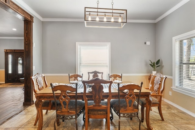 tiled dining area featuring an inviting chandelier and crown molding