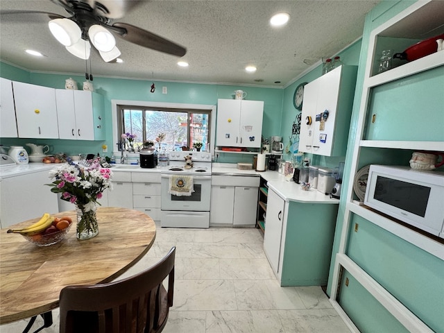 kitchen with white cabinets, light tile floors, washer / clothes dryer, ceiling fan, and white appliances